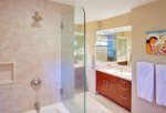 Bathroom features an oversized soaking tub with shower and two vanities